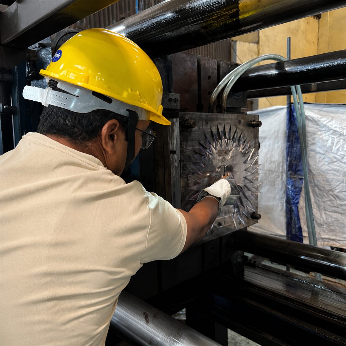 Vaibhav Laxmi Industries technician operating injection moulding machine to manufacture polycarbonate Anti Bird Disks at the Jaipur facility
